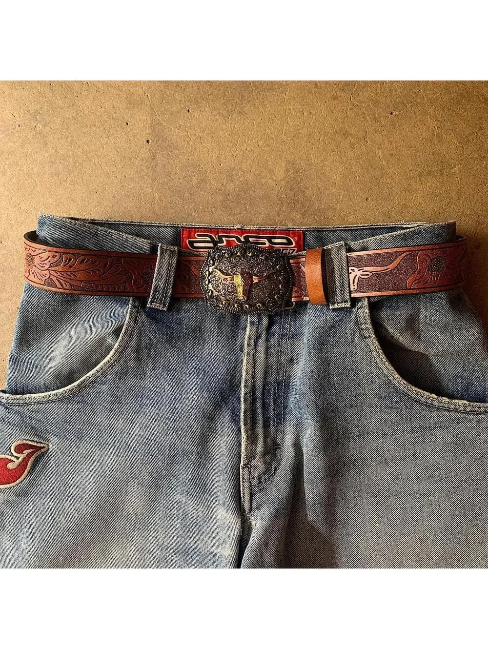American Western Brown leather belt with silver-toned brass buckle, featuring a